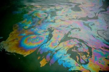 Colorful oil spill in water.