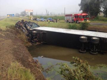 Semi-truck turned over in a ditch.